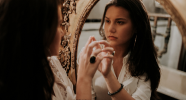 a woman looking in a mirror
